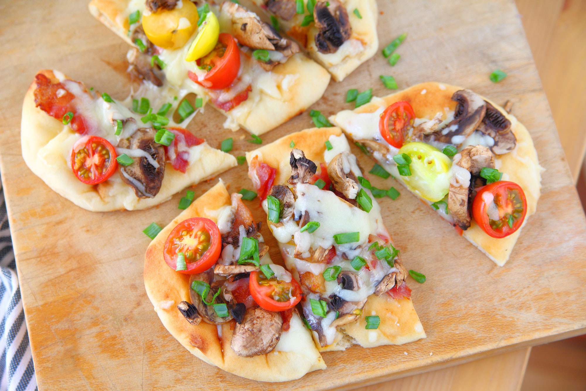 Can't Cook? Assemble some fresh pizzas with raw toppings on a precooked flatbread (naan).